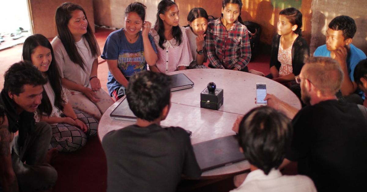 people sitting on floor around a table